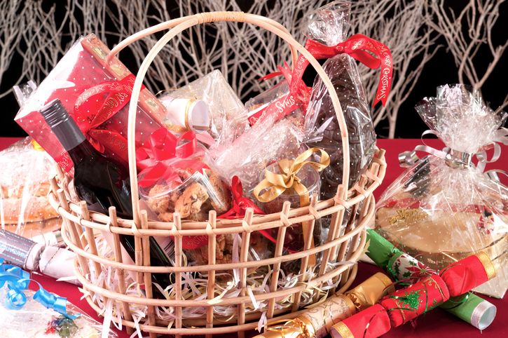 Christmas hamper basket with a chocolate Santa, cookies and a bottle of wine close-up